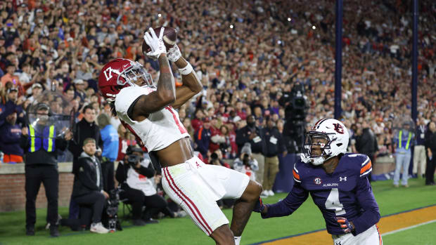 ov 25, 2023; Auburn, Alabama, USA; Alabama Crimson Tide wide receiver Isaiah Bond (17) scores the game winning touchdown over Auburn Tigers cornerback D.J. James (4) during the fourth quarter at Jordan-Hare Stadium. Mandatory Credit: John Reed-USA TODAY Sports
